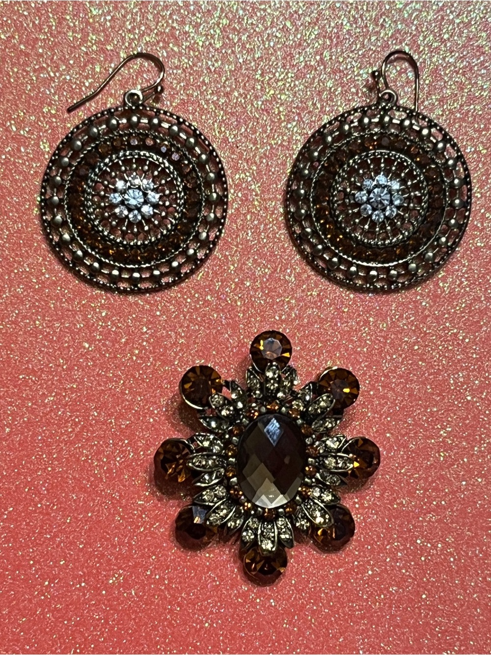 Brown Crystal Floral Brooch and Filigree Hoop Earrings Set earrings are silver.
